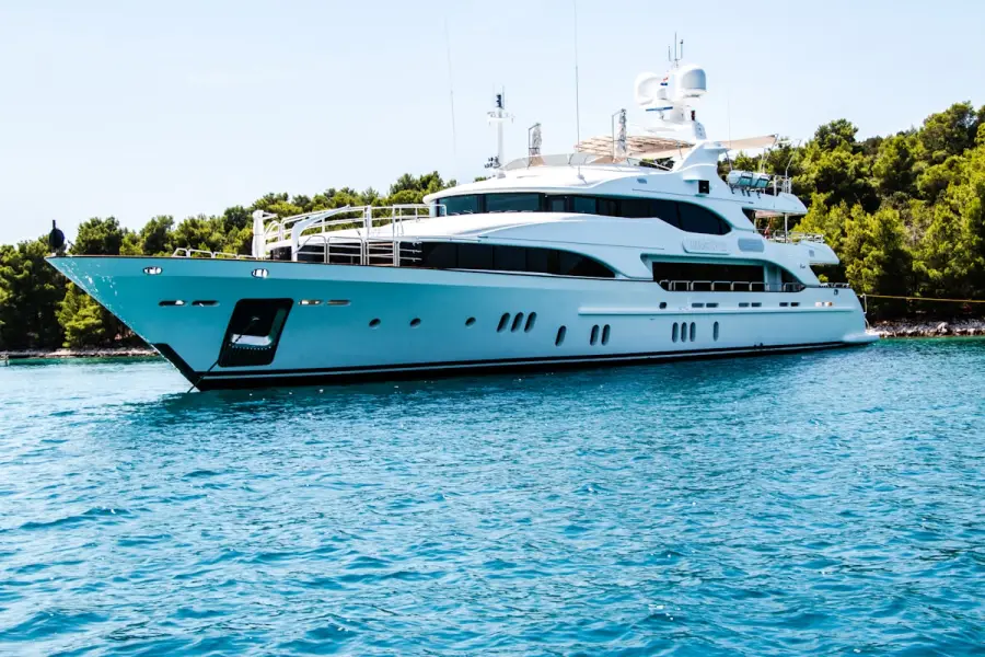 Luxury yacht anchored in clear water away from the crowd